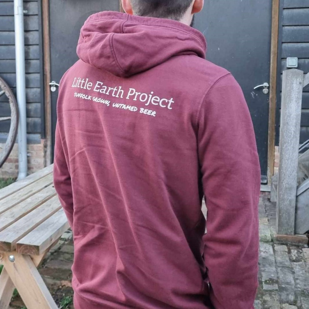 Burgundy overhead hoodie with Little Earth Project name and tagline across upper back.